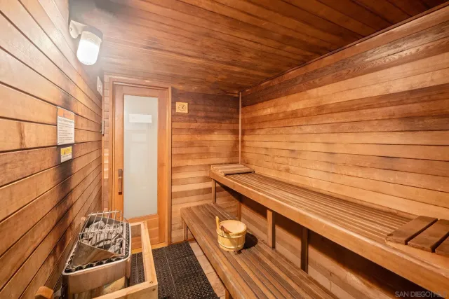 a view of a balcony with wooden floor and a floor to ceiling window