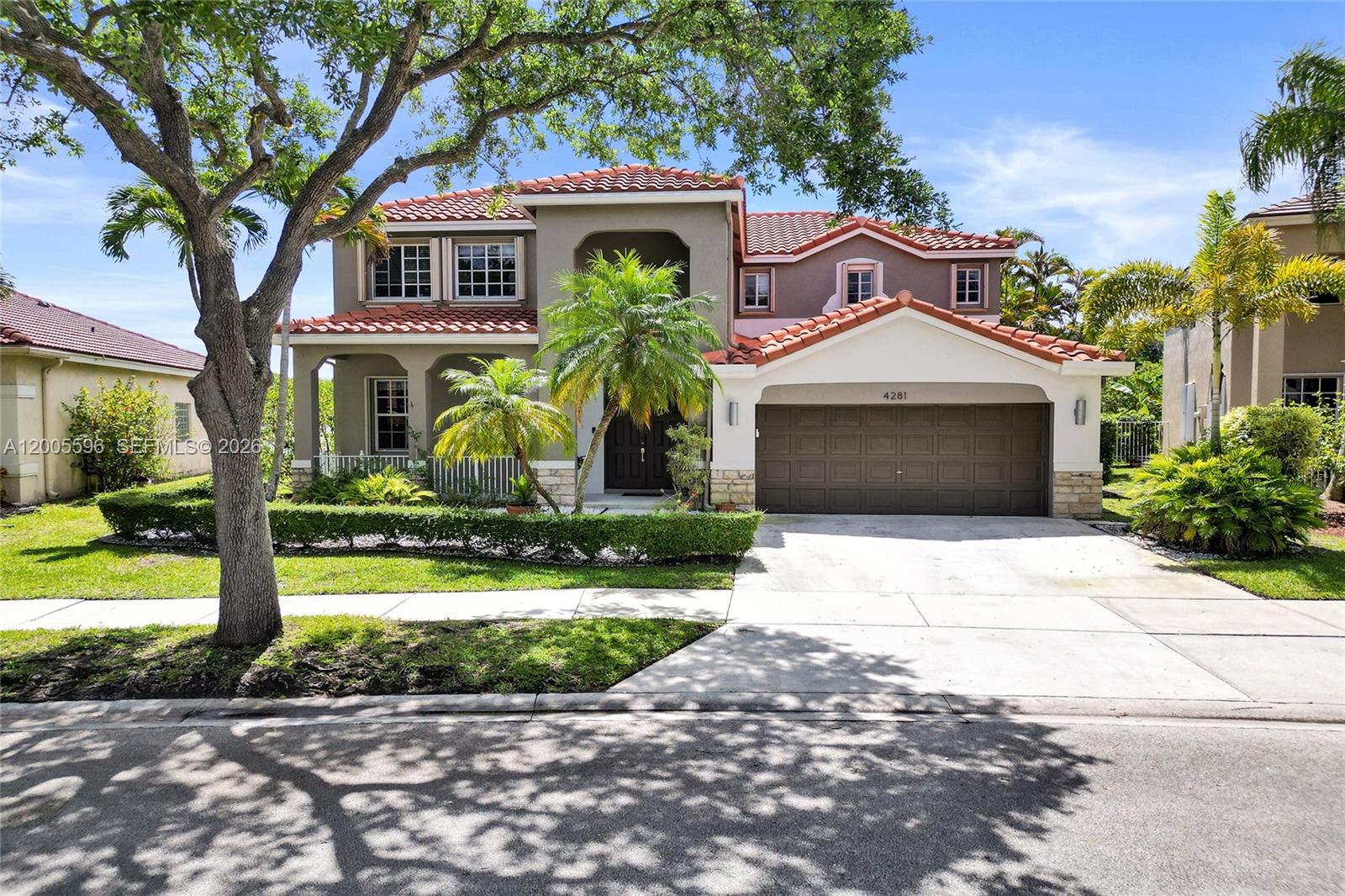 a front view of a house with a yard and garage