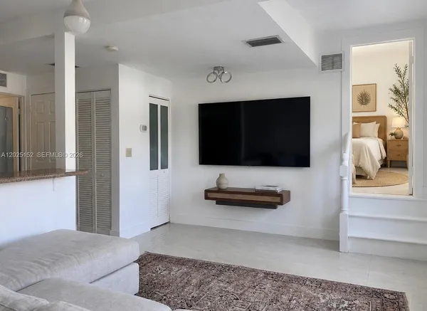 a bedroom with furniture and flat screen tv