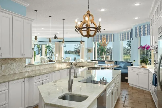 a view of a kitchen with a sink and a chandelier