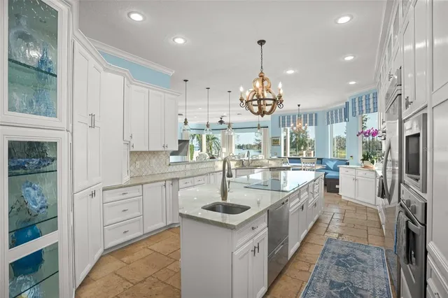 a kitchen with stainless steel appliances granite countertop a sink and refrigerator
