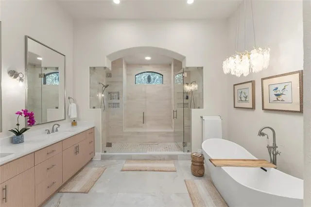 a bathroom with a shower sink mirror and vanity