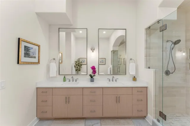 a bathroom with a granite countertop sink mirror vanity and toilet