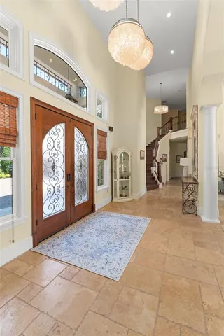 a view of a livingroom with furniture fireplace and windows