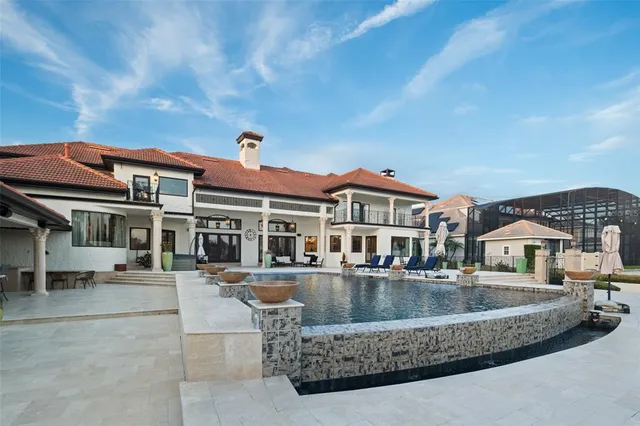 a view of house with garden space and swimming pool