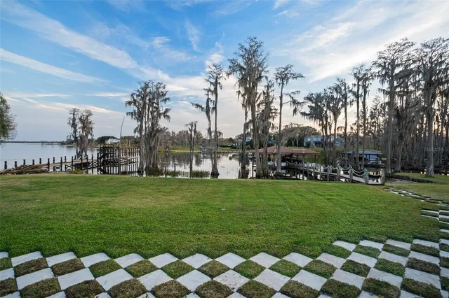 an aerial view of lake and residential houses with outdoor space