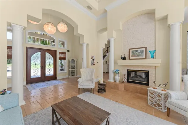 a living room with furniture a fireplace and a large mirror