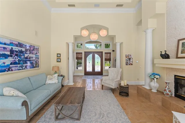 a dining room with furniture a chandelier and wooden floor
