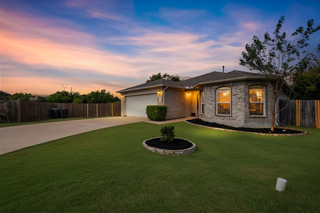 a view of a backyard with table and chairs a fire pit and grass