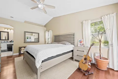 a bedroom with a bed and a large window