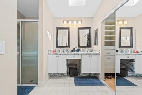 a bathroom with a double vanity sink and a mirror
