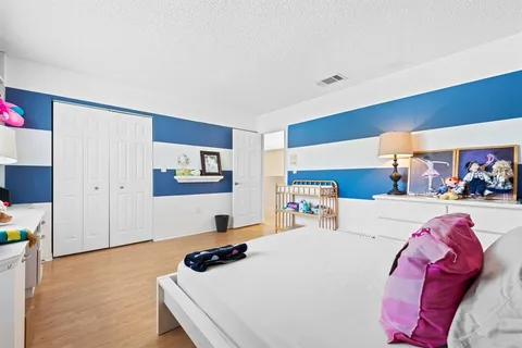 a bedroom with a bed and a couch