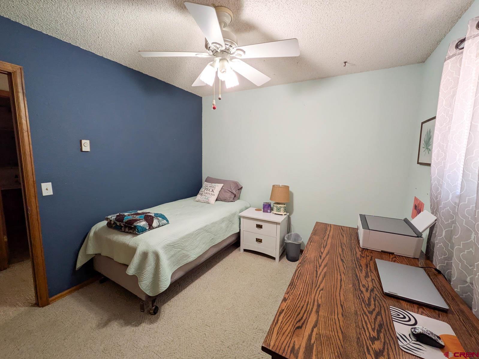 39594 Pitkin Road Paonia, CO 81428 - Photo 11 of 35 a bed room with a bed and a chandelier