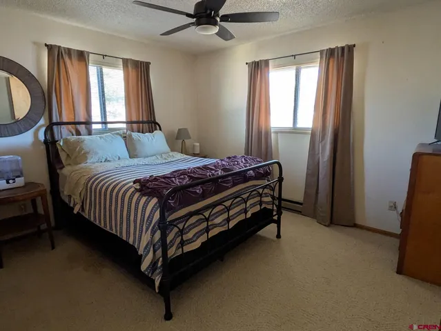 a bedroom with a bed chair and window