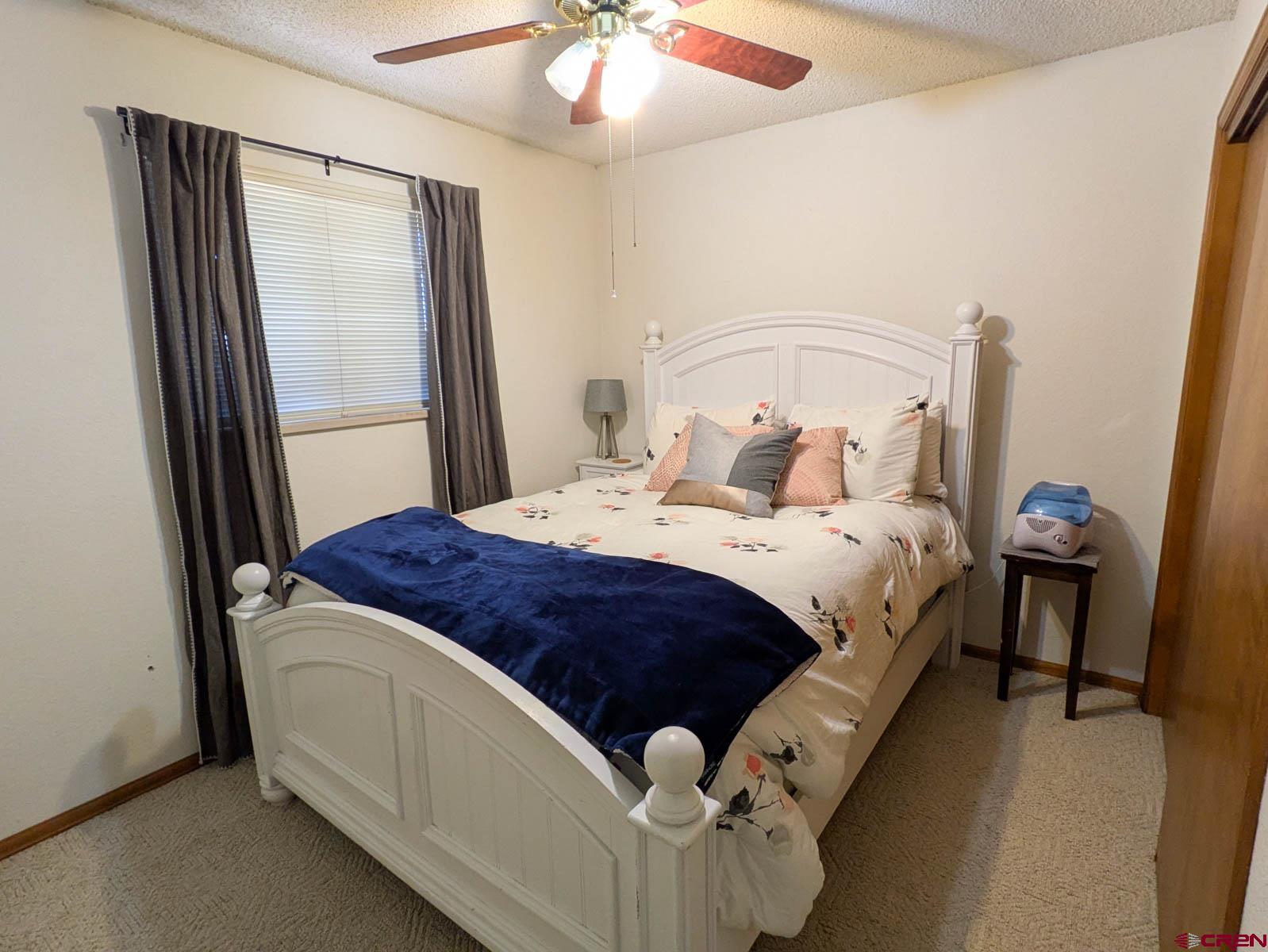 39594 Pitkin Road Paonia, CO 81428 - Photo 16 of 35 a bedroom with a bed and a mirror