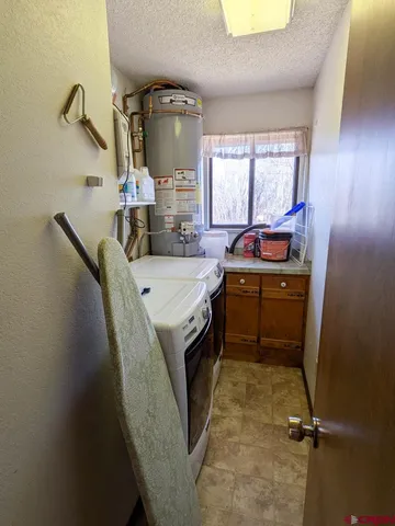 a utility room with sink dryer and washer