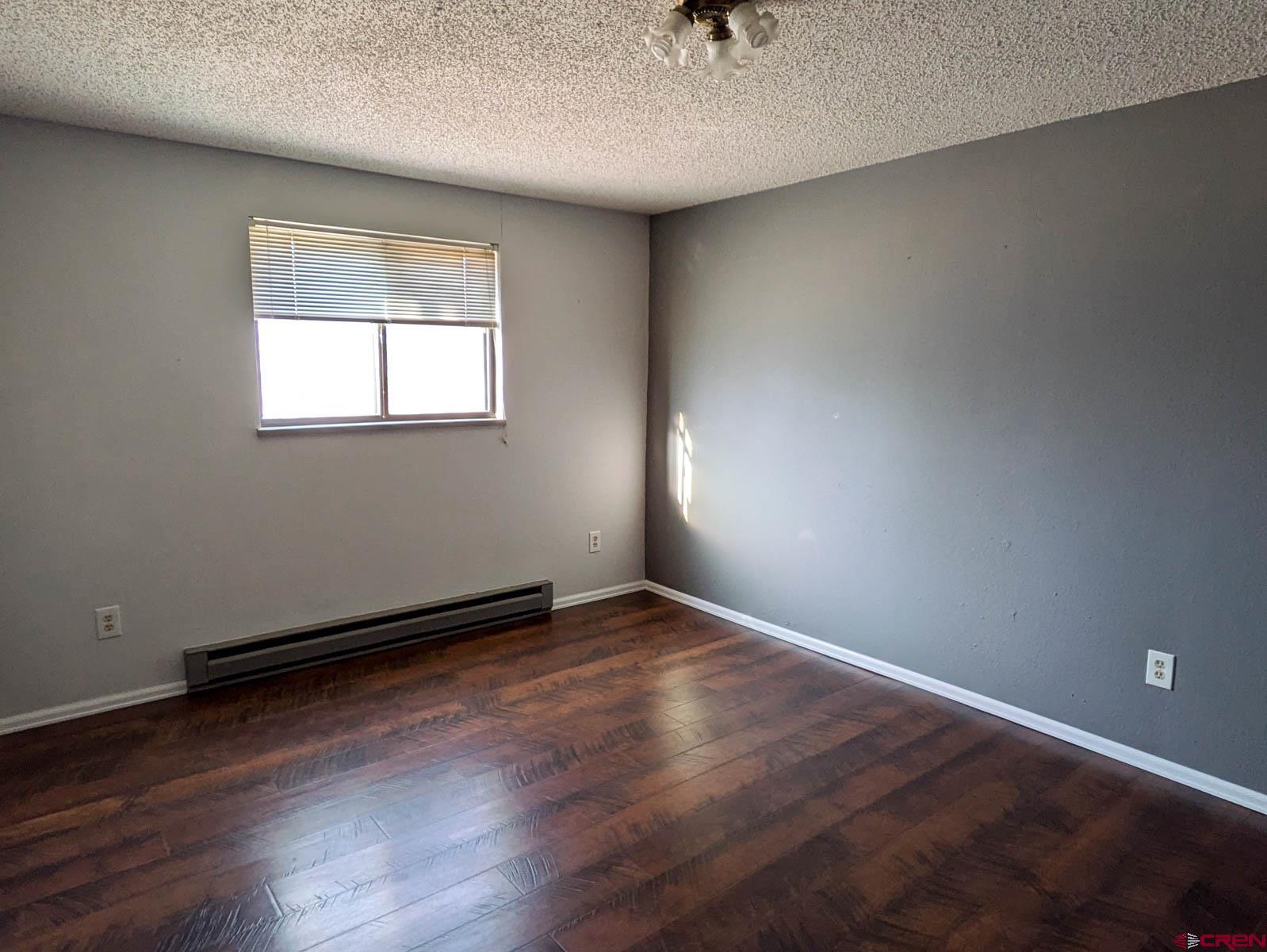 39594 Pitkin Road Paonia, CO 81428 - Photo 19 of 35 an empty room with wooden floor and windows