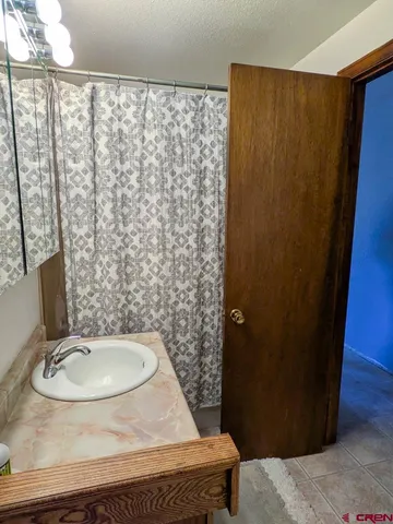 a bathroom with a sink toilet and a mirror