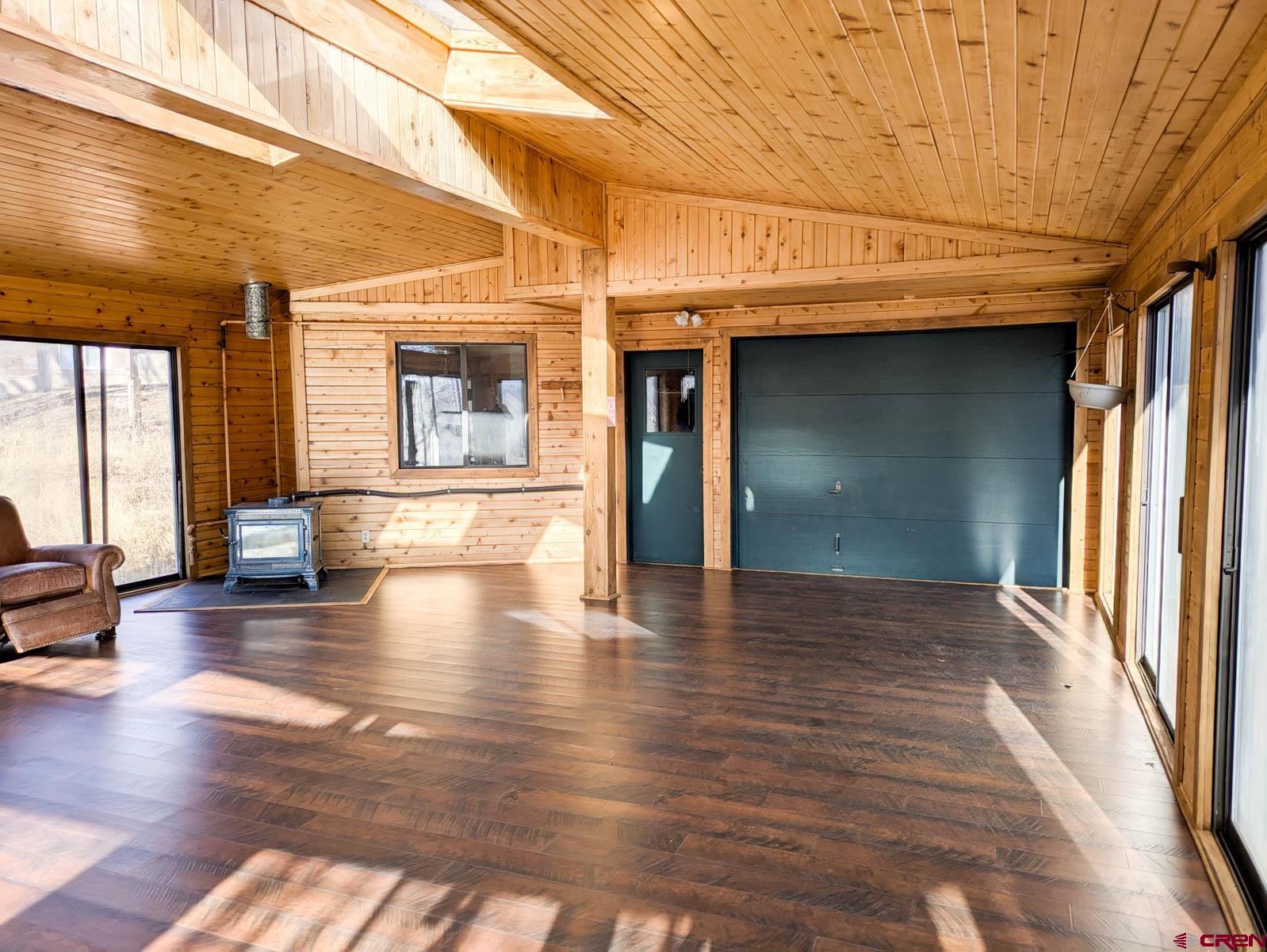 39594 Pitkin Road Paonia, CO 81428 - Photo 29 of 35 a view of an empty room with wooden floor and a window
