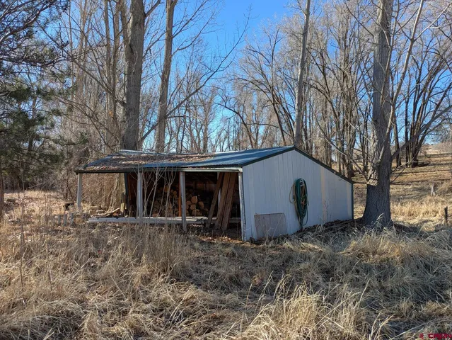 a view of house with backyard