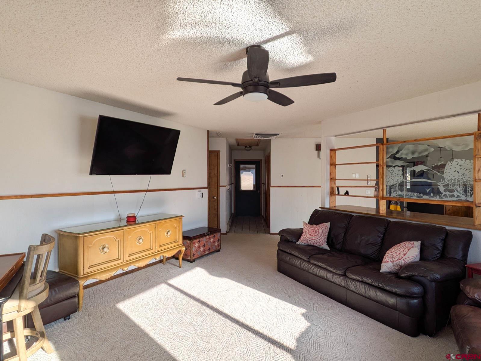 39594 Pitkin Road Paonia, CO 81428 - Photo 4 of 35 a living room with furniture and a flat screen tv