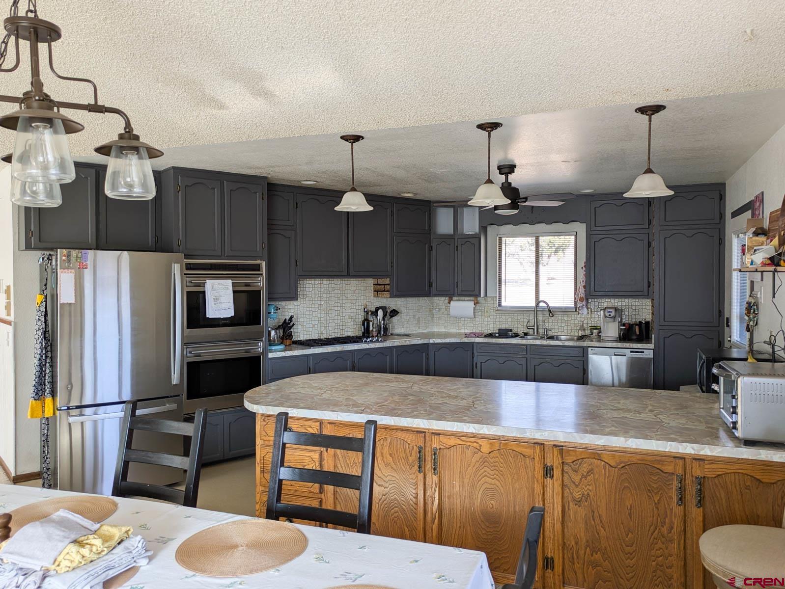 39594 Pitkin Road Paonia, CO 81428 - Photo 7 of 35 a large kitchen with a table chairs and a wooden floor