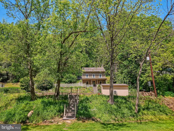 a backyard of a house with lots of green space and fountain