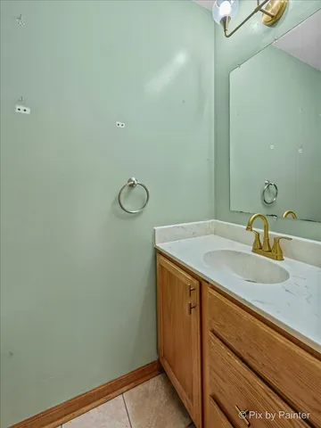 a bathroom with a granite countertop sink and mirror