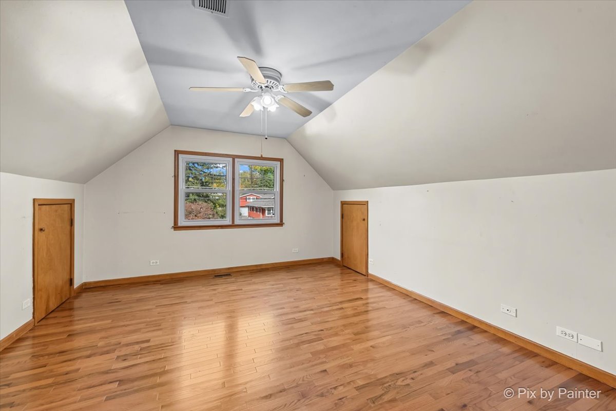 31 West Harrison Road Lombard, IL 60148 - Photo 14 of 31 an empty room with wooden floor chandelier fan and windows