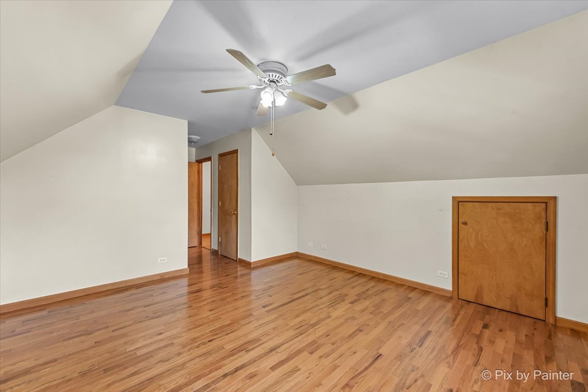 31 West Harrison Road Lombard, IL 60148 - Photo 15 of 31 an empty room with wooden floor chandelier fan and windows