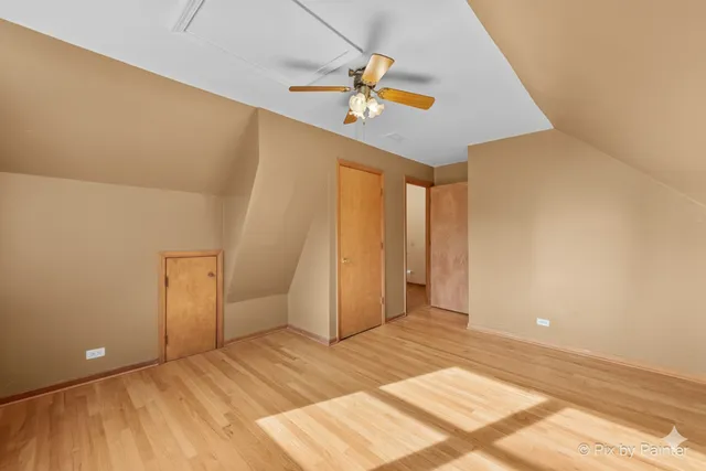 a view of a hallway with a ceiling fan