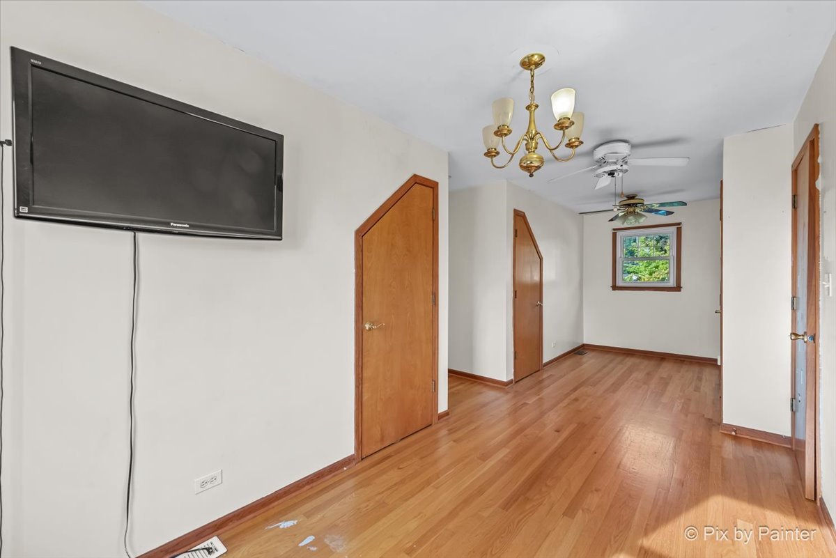 31 West Harrison Road Lombard, IL 60148 - Photo 20 of 31 a view of livingroom with hardwood floor and ceiling fan