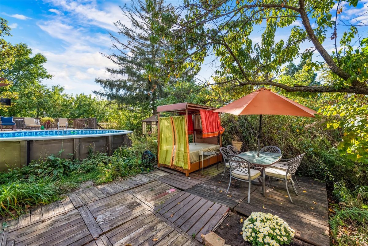 31 West Harrison Road Lombard, IL 60148 - Photo 28 of 31 a wooden bench sitting in front of a building