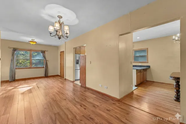 a view of a room with wooden floors and natural light