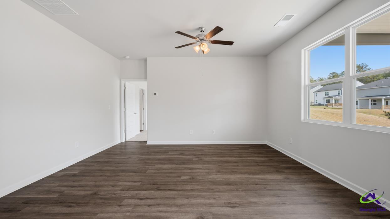 227 Cattle Drive Perry, GA 31069 - Photo 25 of 40 a view of empty room with wooden floor and fan