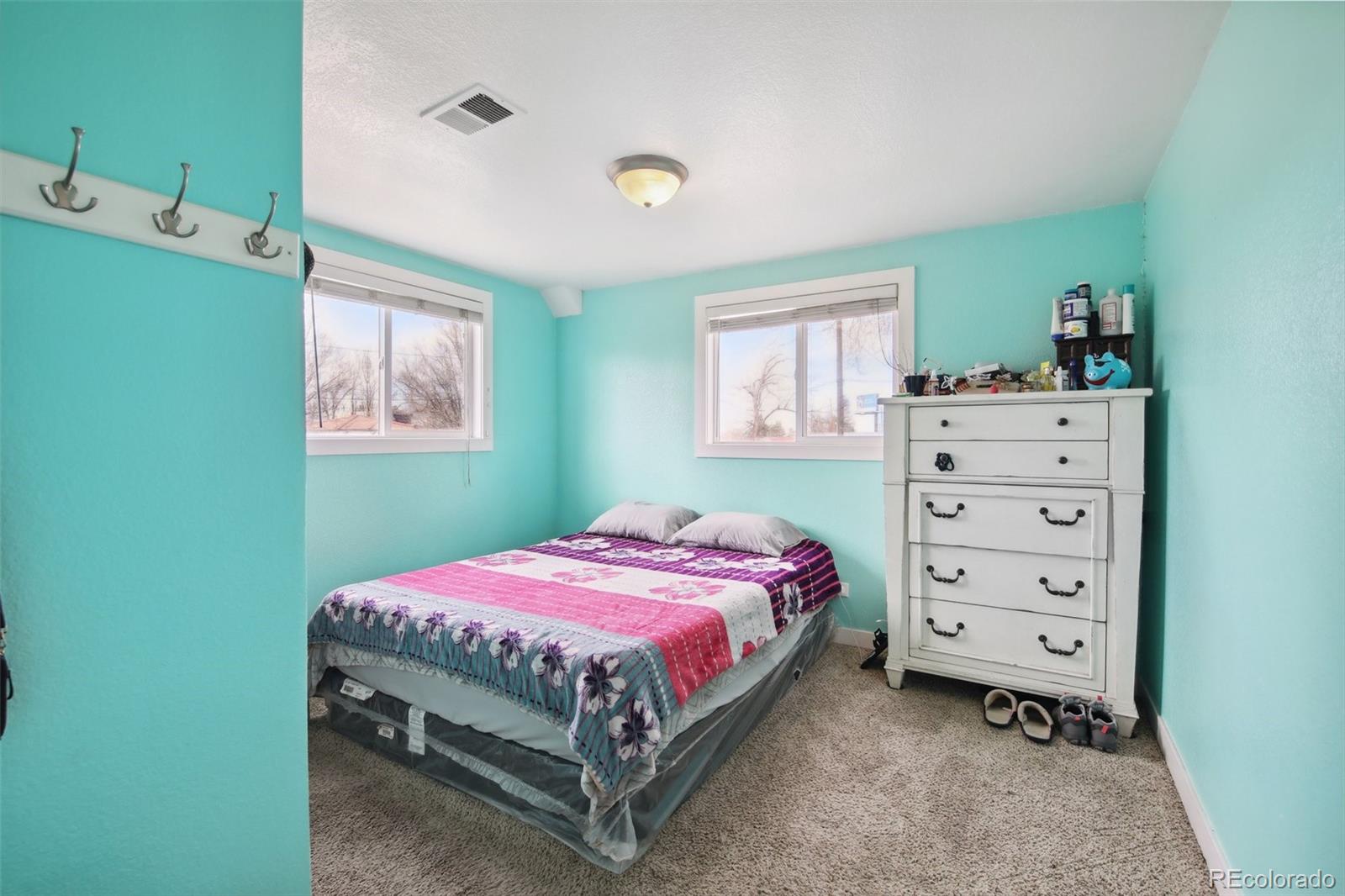 950 South Wolff Street Denver, CO 80219 - Photo 11 of 39 a bedroom with a bed and a window