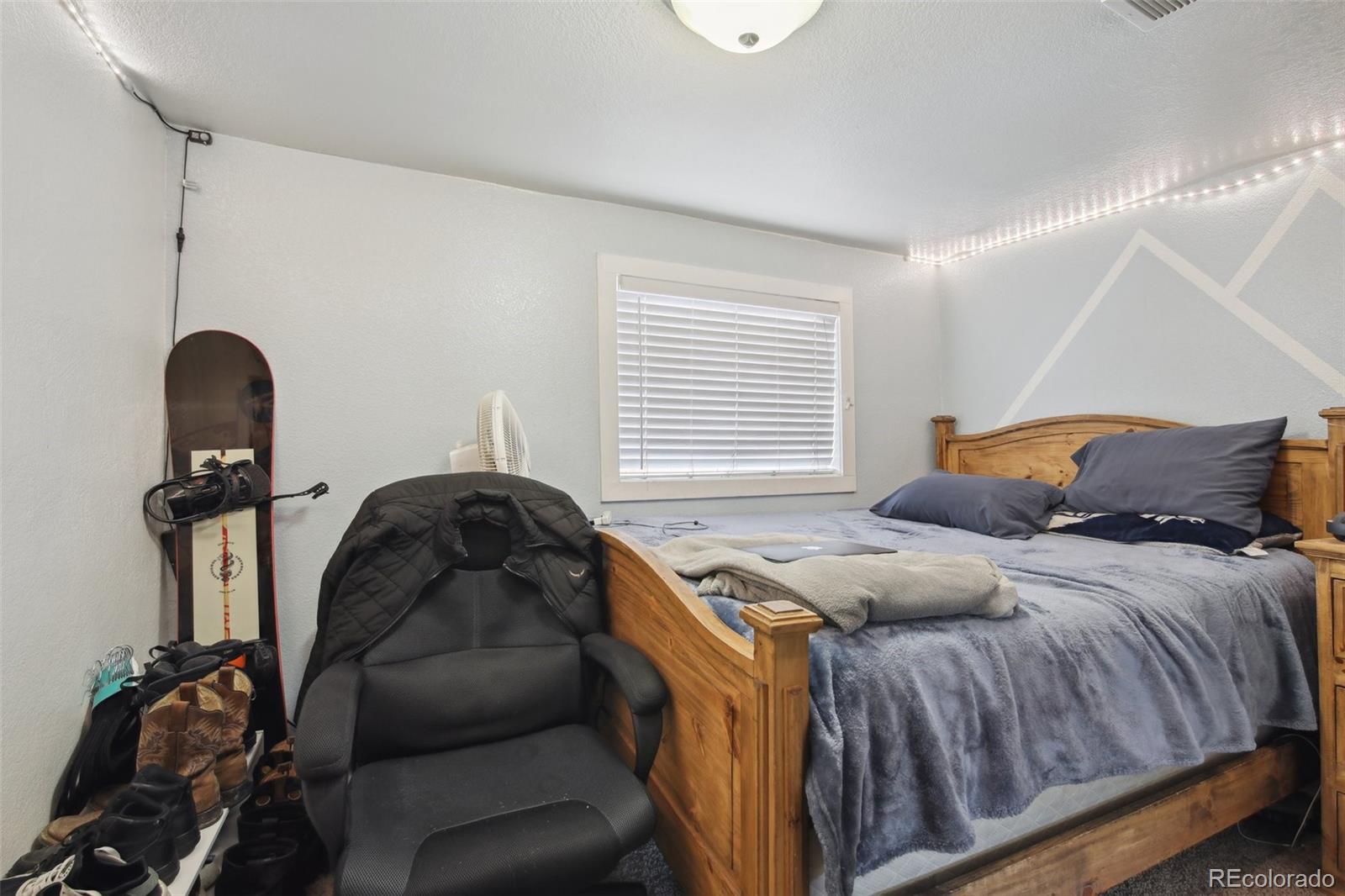 950 South Wolff Street Denver, CO 80219 - Photo 13 of 39 a bed sitting in a bedroom next to a window