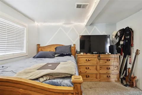 a bedroom with a bed and a flat tv screen
