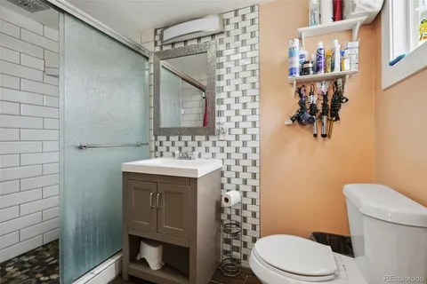 a bathroom with a toilet sink and shower