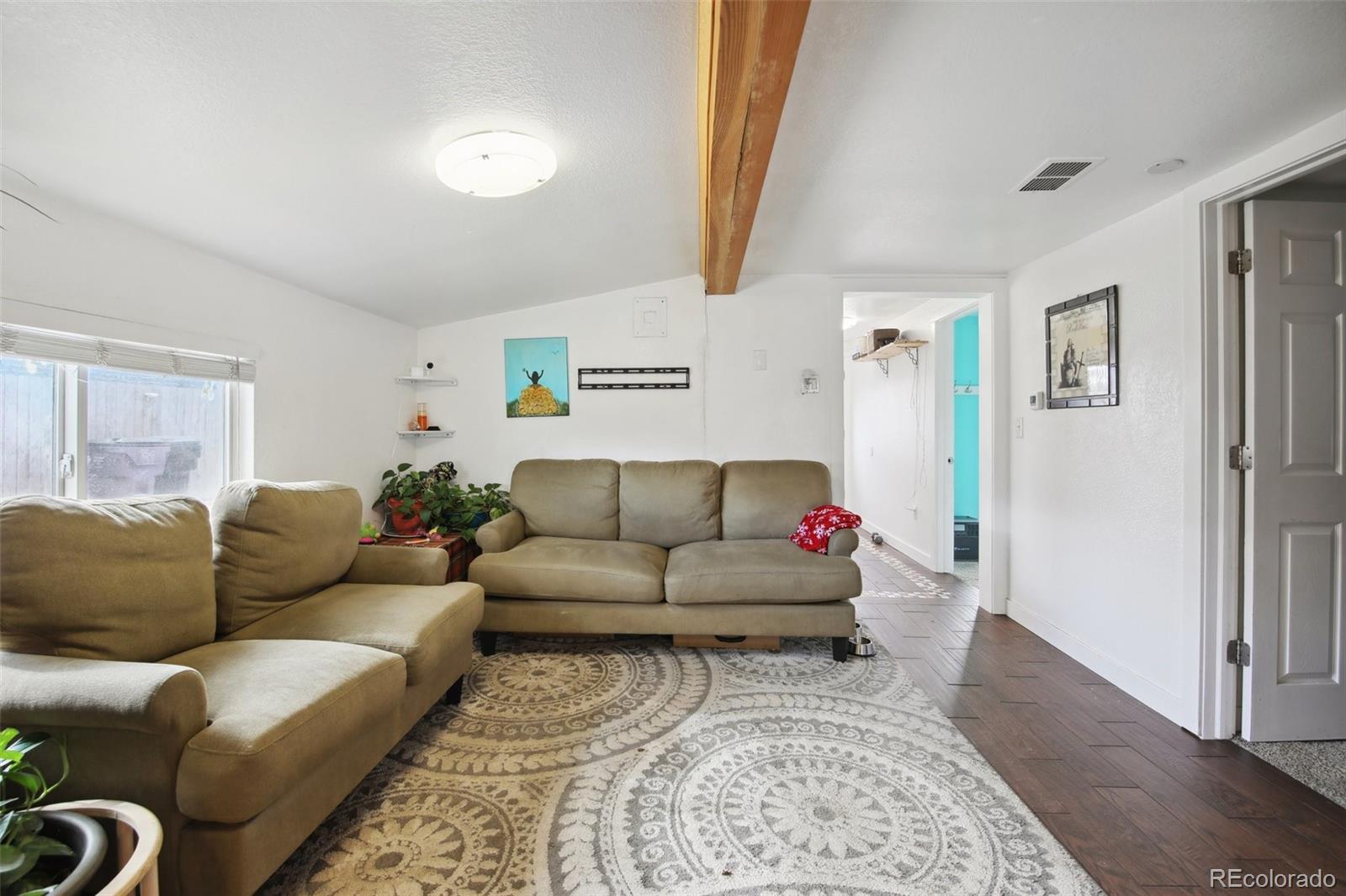 950 South Wolff Street Denver, CO 80219 - Photo 3 of 39 a living room with furniture and a rug