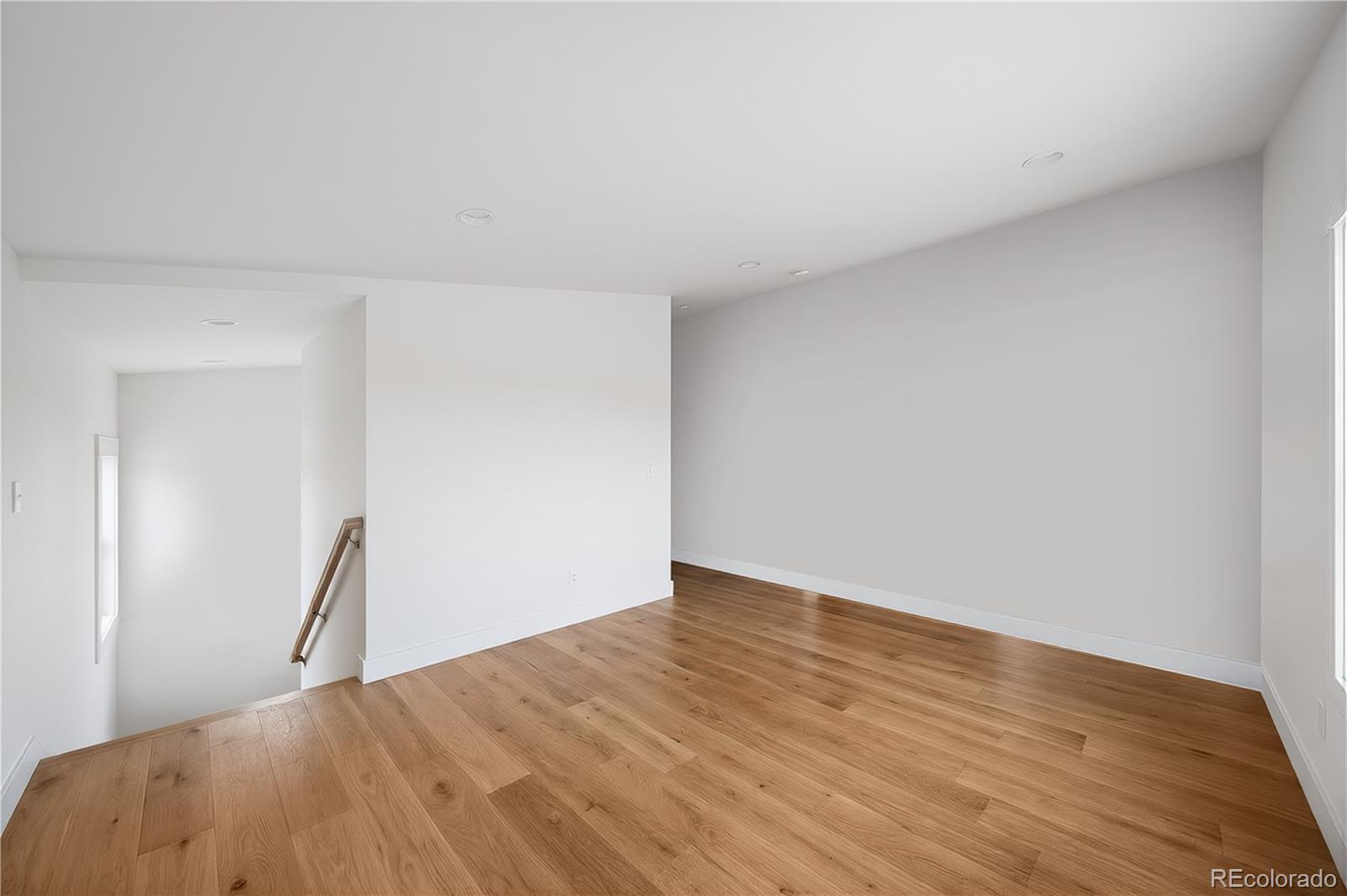 950 South Wolff Street Denver, CO 80219 - Photo 34 of 39 a view of empty room with wooden floor