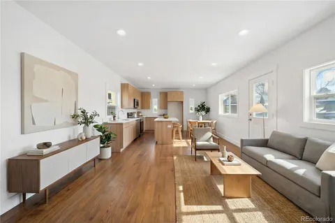a view of kitchen and hall with wooden floor