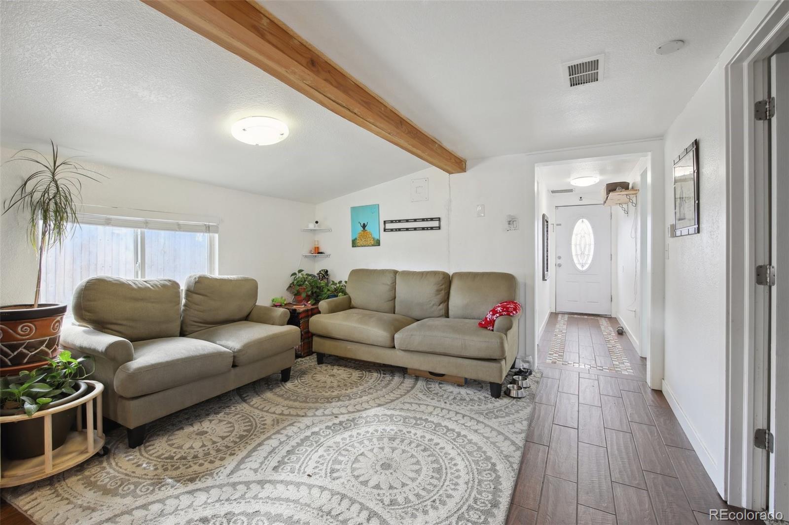 950 South Wolff Street Denver, CO 80219 - Photo 4 of 39 a living room with furniture and a wooden floor