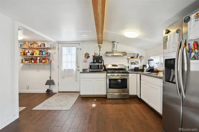 a kitchen with stainless steel appliances a refrigerator sink and cabinets