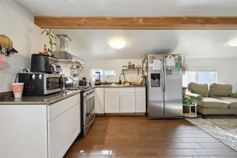 a kitchen with stainless steel appliances a refrigerator and cabinets