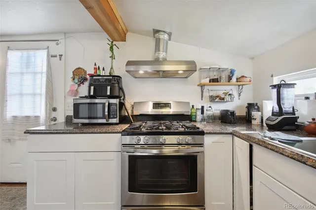 a kitchen with stainless steel appliances granite countertop a stove and a sink