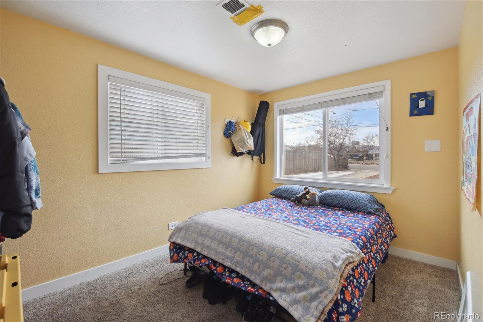 950 South Wolff Street Denver, CO 80219 - Photo 9 of 39 a bedroom with a bed and a window