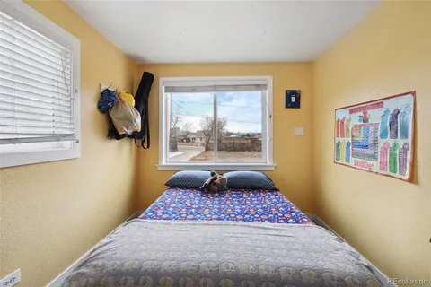 a bedroom with a bed and a window