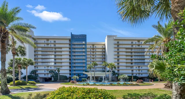 a front view of a multi story building with yard
