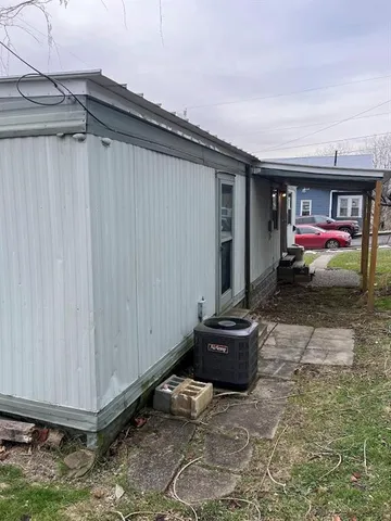a view of kitchen with wooden floor and cabinets